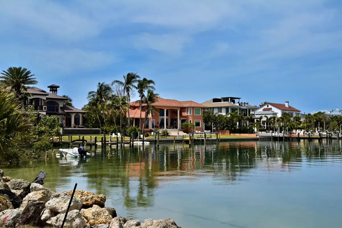 Waterfront homes and palm trees along a canal in Sarasota, Florida